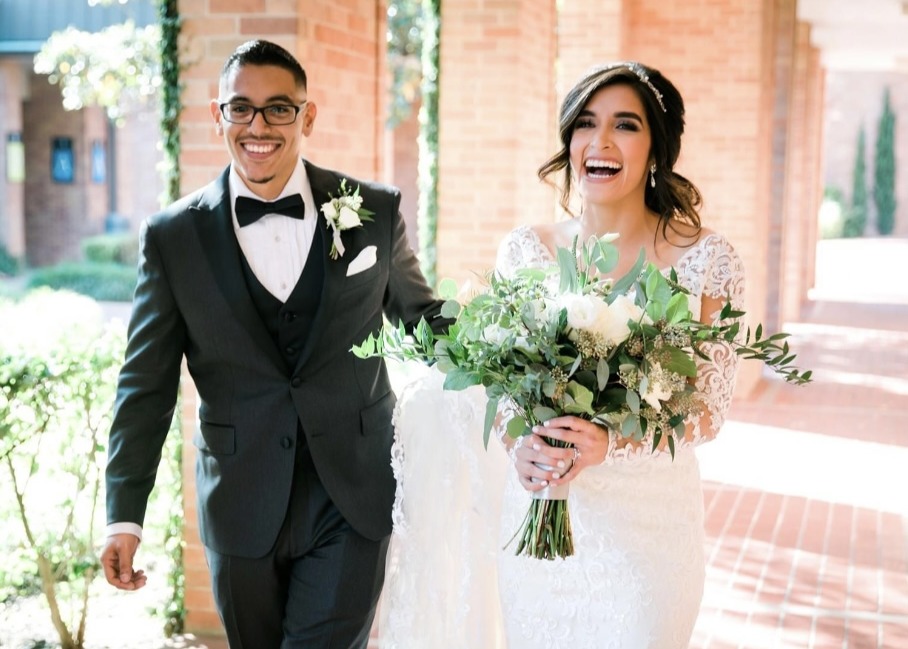 Man and woman with their hands up celebrating marriage