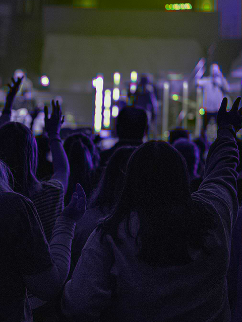 People with their hands up in praise